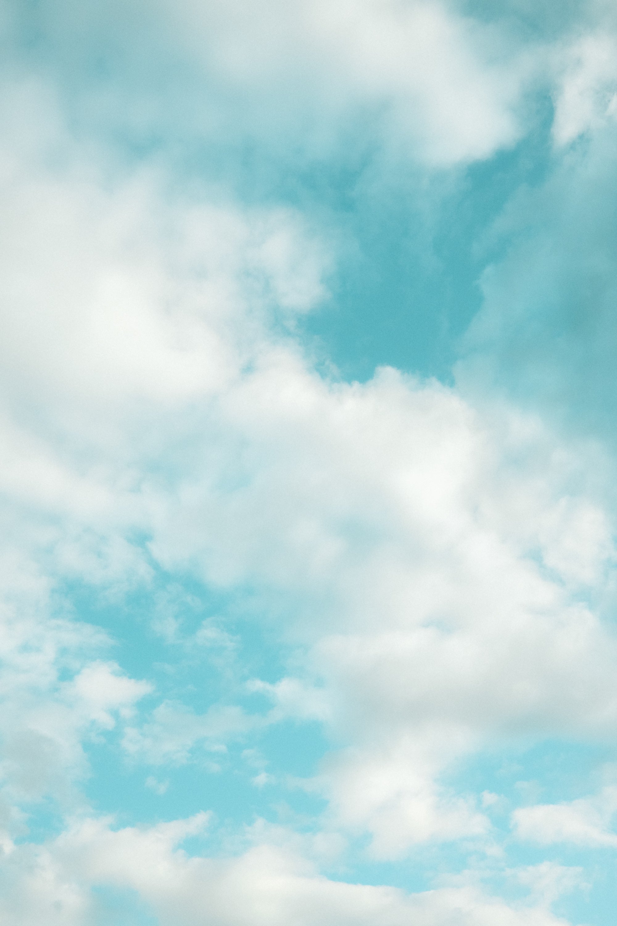 Pastel blue sky with soft white clouds