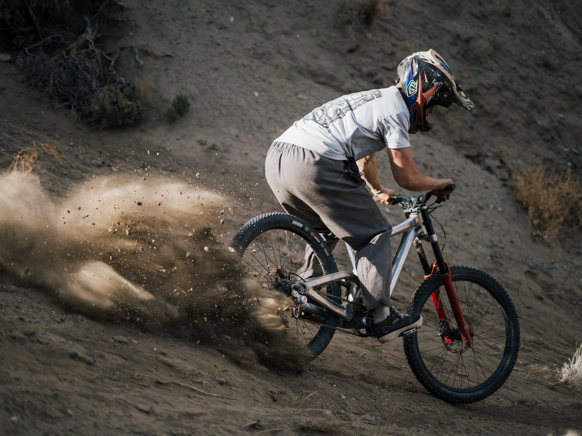 Biker in action on a dirt trail with dust in the air with Zone Pro